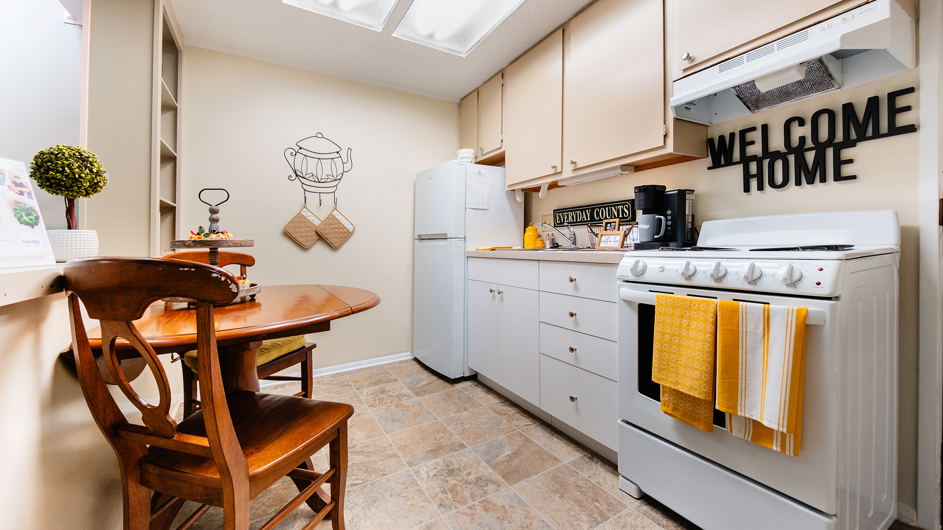 Apartment kitchen with yellow towels and accents