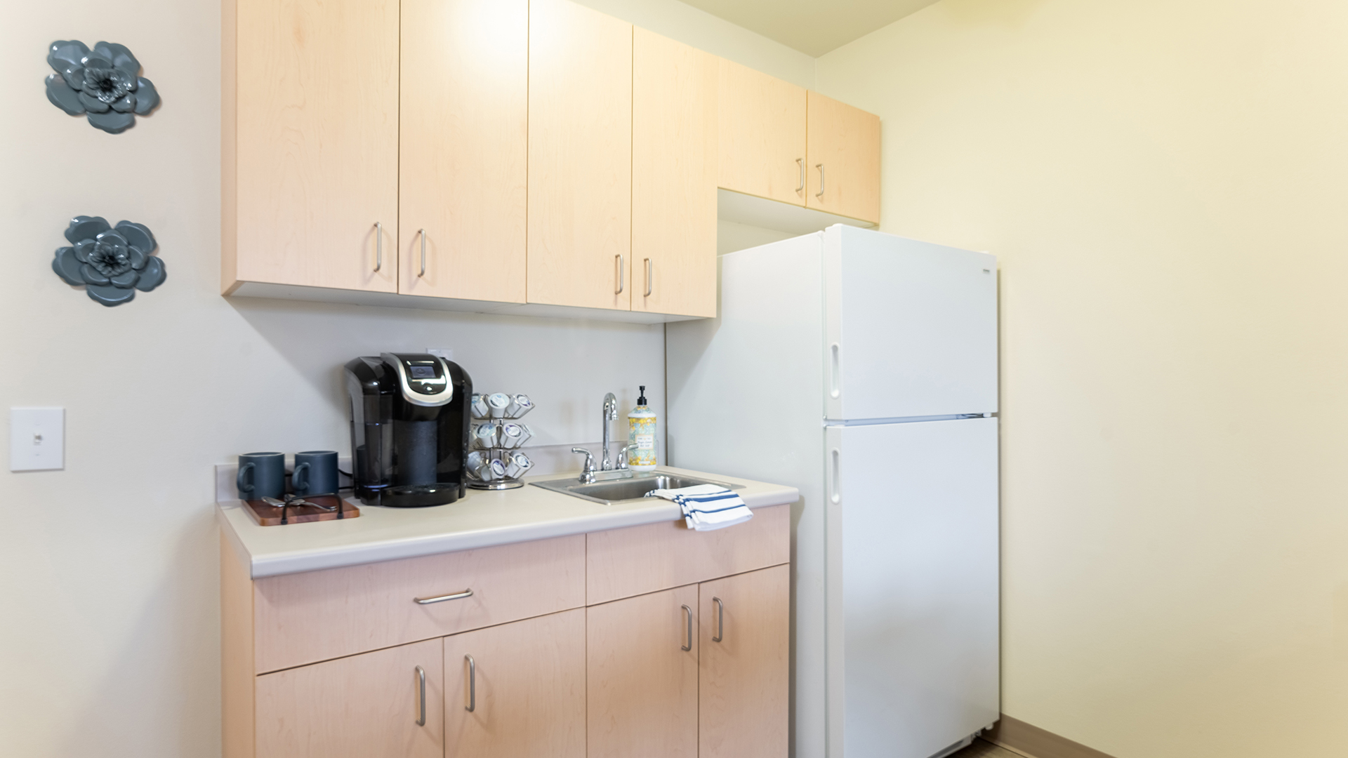 Kitchenette with coffee pot and refrigerator