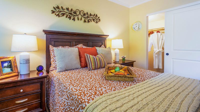 Furnished senior apartment bedroom with closet at Atria Valley View.