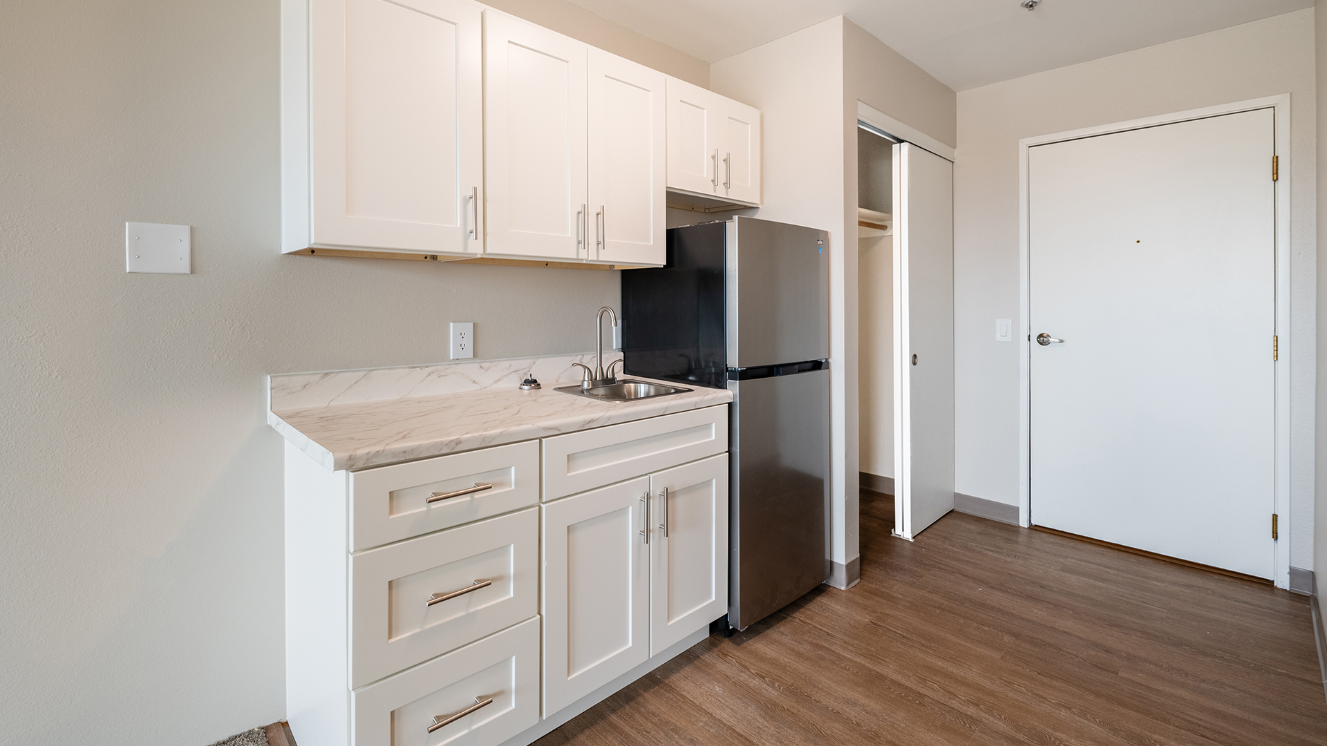 Holiday Elm Park Estates apartment kitchen equipped with modern appliances and cabinets